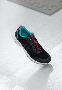 Black athletic shoe with turquoise lining and pink accents. Features a textured upper, thick white sole, and contrasting laces.