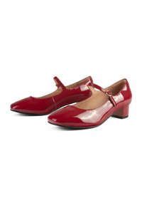 Red patent leather Mary Jane shoes with a square toe, low block heel, and adjustable strap featuring a round metallic buckle.