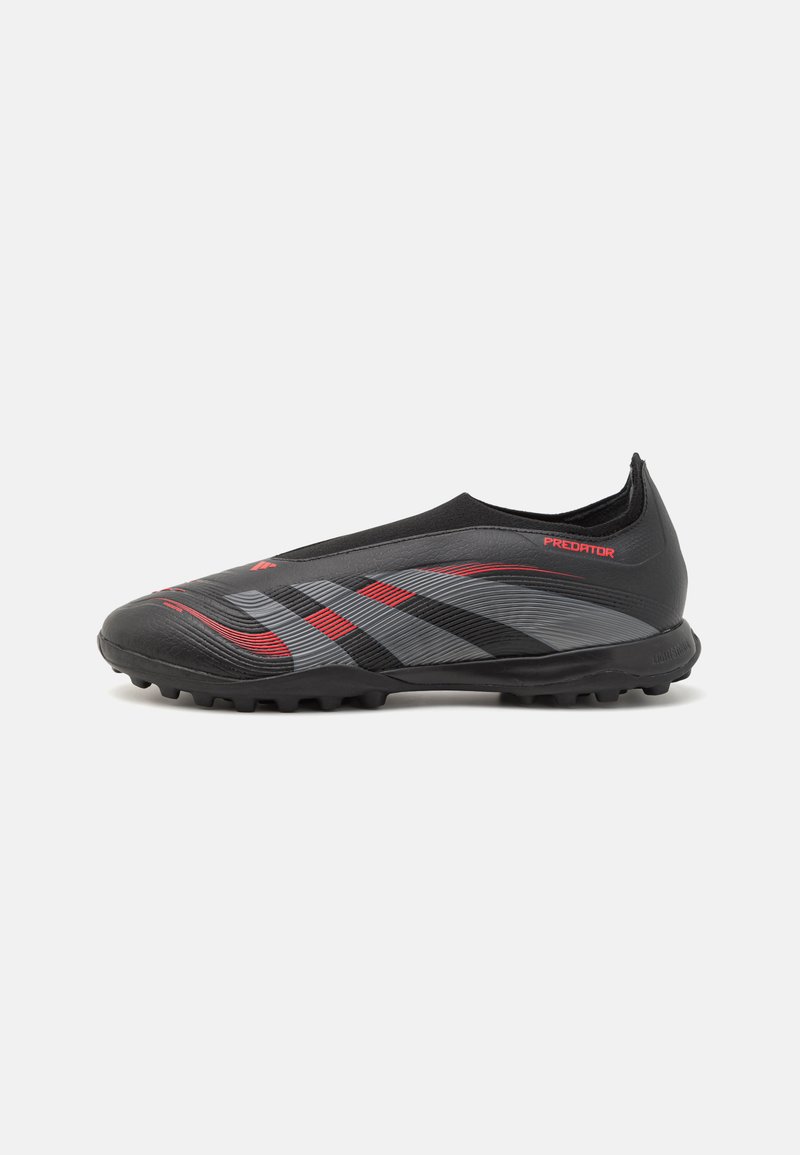 Black synthetic football boots with red and grey accents, low-profile design, textured surface, and rubber studs for traction.