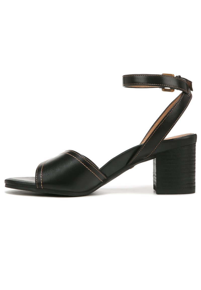 Zwarte leren sandaal met hak, voorzien van een dikke, gestructureerde blokhak. Heeft een enkelbandje en een open teenontwerp met gekruiste bandjes.