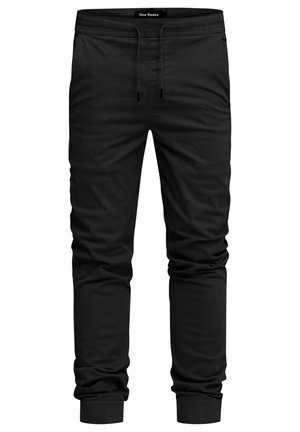 Black jogger pants made of soft fabric, featuring an elastic waistband with drawstring, side pockets, and tapered cuffs.