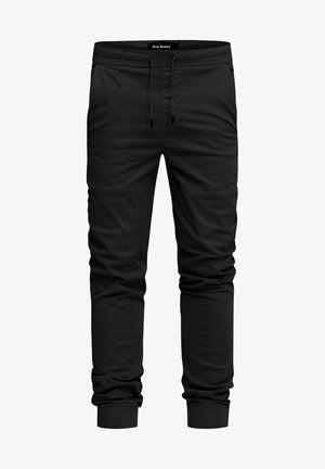 Black jogger pants made of soft fabric, featuring an elastic waistband with drawstring, side pockets, and tapered cuffs.