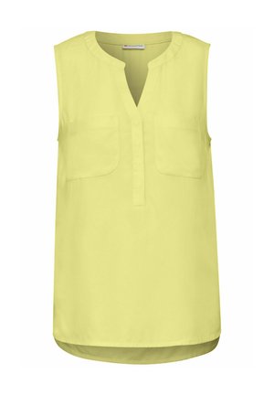 Toppi ilman hihoja, jossa on V-pääntie ja kirkkaan keltainen väri. Edessä on kaksi taskua ja kaareva helma. Valmistettu kevyestä kankaasta, jossa on sileä pinta.