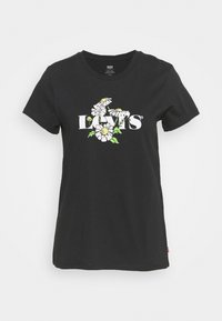 Černé bavlněné tričko s velkým bílým logem "Levi's" s květinovými akcenty v žluté a zelené barvě. Krátké rukávy a kulatý výstřih.