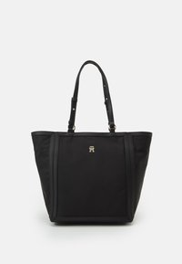 Sac fourre-tout noir en nylon avec des accents en cuir. Doté de bretelles ajustables et d'un logo doré à l'avant. Texture lisse, forme structurée.