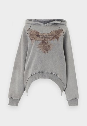 Γκρι cropped φούτερ από μαλακό ύφασμα. Διαθέτει εικόνα αετού με το κείμενο "Just Cavalli", μεταλλικά καρφιά κατά μήκος της κουκούλας και χαλαρά μανίκια.