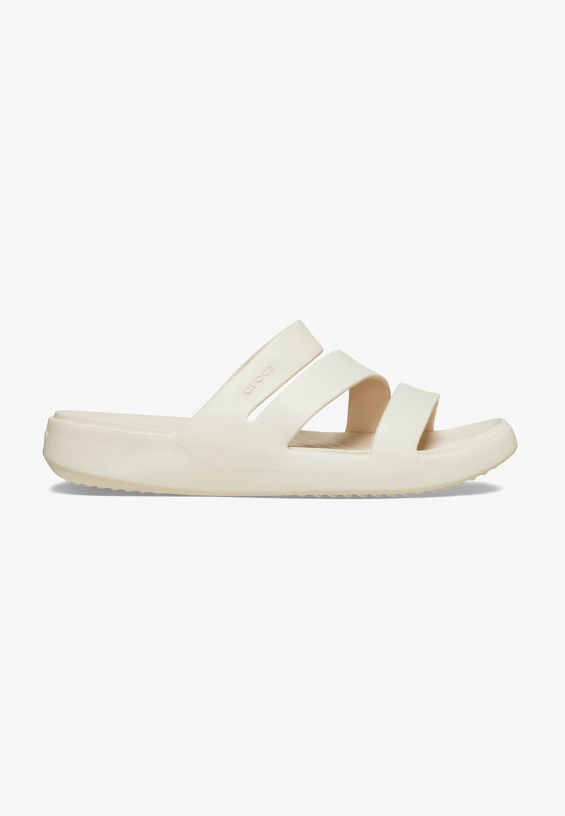 Sandale beige à enfiler avec deux larges brides et une semelle épaisse, conçue pour une utilisation décontractée et le confort.