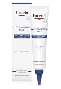 Eucerin UreaRepair Plus Creme Tube mit blauen Akzenten, beschriftet mit "30% Urea Creme", neben einer passenden Box. Beide sind weiß mit roten und blauen Schriftzügen.