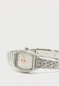 Silver stainless steel watch with a rounded rectangular case, white textured dial, pink hour markers, and a linked bracelet strap.