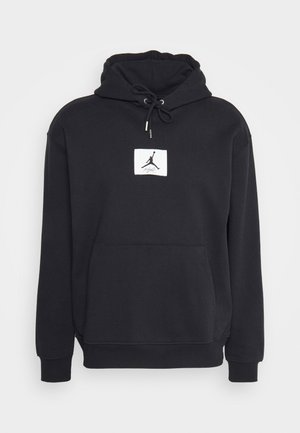 Zwarte hoodie van een katoenmix, met een voorste kangoeroe-pocket en een groot wit vierkant logo met een zwarte silhouet.