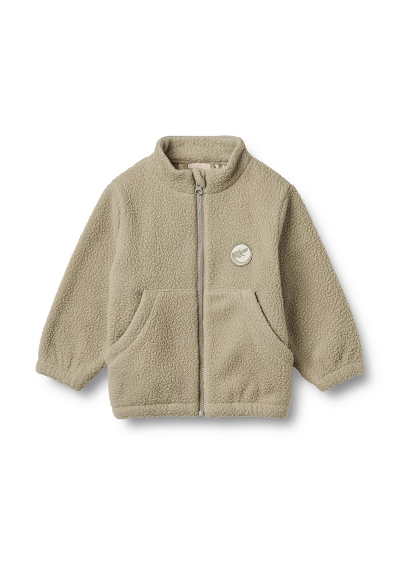 Veste en polaire beige clair avec un col montant, une fermeture éclair à l'avant, deux poches latérales et un détail en patch circulaire sur la poitrine gauche.