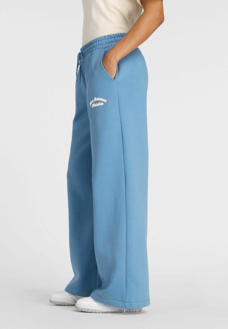 Light blue wide-leg sweatpants, made from soft cotton blend, featuring an elastic waistband, drawstring, and front pockets. Logo embroidered on thigh.