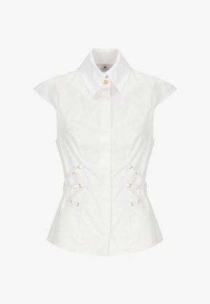 Blusa bianca donna senza maniche con colletto appuntito, bottoni frontali e cinturini laterali regolabili con fibbie dorate.