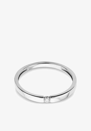 Dünner Silberring mit einem kleinen runden Diamanten in einem minimalistischen, modernen Band vor weißem Hintergrund.