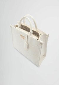 Borsa a tracolla bianca trapuntata con manici doppi, hardware dorato e scomparto con zip. L'interno presenta una fodera a fantasia e una tasca centrale.