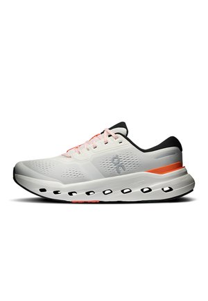 White athletic shoe with black sole, orange stripe on the midsole, black heel detail, mesh upper, and white laces, shown in side profile.