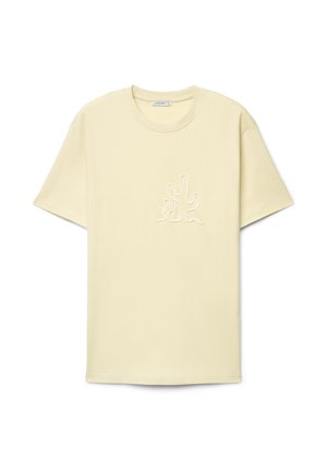 Hellbeiges T-Shirt mit kurzen Ärmeln, Rundhalsausschnitt und erhabenem Kaktus-Design auf der Brust, Markenetikett innen am Kragen.