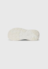 White running shoe sole with textured grip patterns and raised accents, featuring a curved shape and a durable, rubber material.