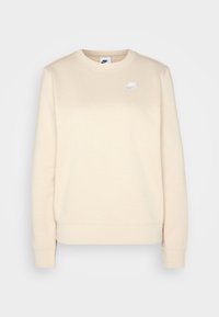 Ljusbeige Nike sweatshirt med rundad halsringning, långa ärmar, ribbade muddar och en vit logotyp på vänster bröst. Slät bomullsblandning.