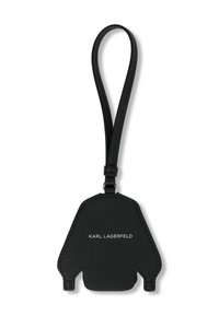 Black leather luggage tag shaped like a bear, featuring a smooth texture, embossed brand name, and a loop for attachment.