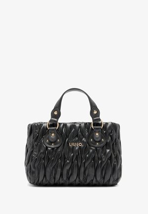 Zwarte handtas met een quilted textuur, voorzien van twee ronde handvatten, gouden hardware en een logo. Compact ontwerp met een gestructureerde vorm.