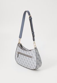 Light blue handbag in textured material with a curved shape. Features gold hardware and a front zip pocket with a patterned design.