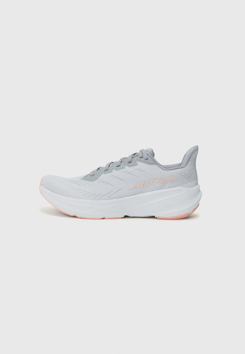 Light gray athletic shoe with a textured mesh upper, tonal laces, and a cushioned white sole featuring a pink accent on the outsole.