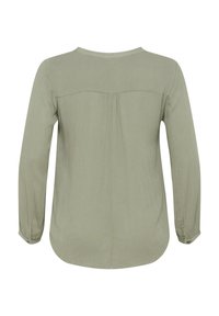 Hellgrün, langärmlige Bluse mit rundem Ausschnitt, Details mit Rückfalte und umgeschlagenen Bündchen. Weicher, strukturiertes Material mit abgerundetem Saum.