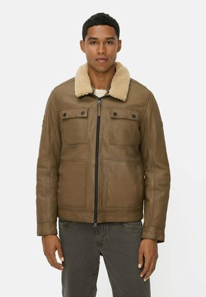 Braune Lederjacke mit einem cremefarbenen Schaffellkragen, ausgestattet mit zwei Brusttaschen, einem Reißverschluss vorne und glatter Textur.