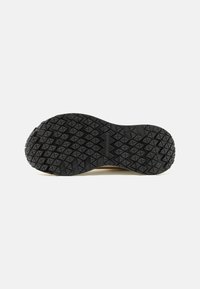 Black rubber shoe sole with a textured, triangular pattern and a smooth edge. Features the word "commuters" embossed in the center.