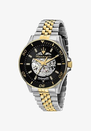 Automatische wristwatch met zwart dial, gouden accenten, roestvrij staal en vergulde armband, met een ingewikkelde mechanische beweging. Waterbestendig tot 100 meter.
