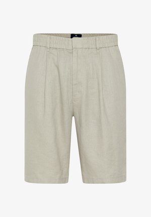 Svetlo bež kratke hlače iz lanu z elastičnim pasom, gubanjem spredaj in ravnim krojem. Brez vidnih žepov ali okraskov.