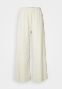 Pantalones de pierna ancha en un tejido texturizado color crema con una cintura elástica. Presentan un material suave y ligero adecuado para el uso casual.