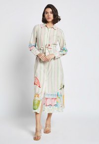 Knopf-Down, langärmliges Kleid in hellgrünen Streifen mit bunten, strandthemenbezogenen Illustrationen, tailliert und mit einem kragenförmigen Ausschnitt.