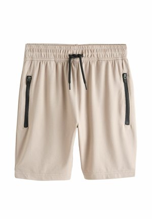 Beige elastiske shorts med sort snørre i taljen og to lodrette lynlåslommer på forsiden mod hvid baggrund.
