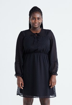 Black dress with a textured, sheer overlay, long puff sleeves, and a drawstring neck. Includes a fitted waist and ruffled cuffs.