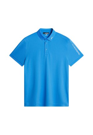 Polo bleu en tissu lisse, avec un col, des manches courtes et le texte "J.LINDEBERG" brodé sur la manche.