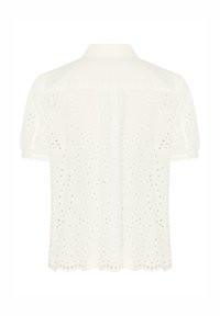 Blouse blanche à manches courtes avec col, présentant une broderie ajourée à motif floral et un ourlet festonné, vue de dos.