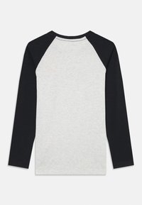 Long-sleeve shirt with a light gray body and black raglan sleeves. Made of soft fabric with a rounded neckline and straight hem.
