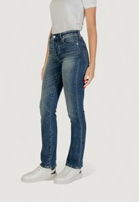 Vaqueros ajustados de denim en color azul, con una cintura de altura media, diseño de cinco bolsillos, un ligero desvanecimiento y detalles bordados a lo largo de los lados.