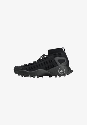Black outdoor shoe featuring a high ankle design, textured upper, and rugged sole with pronounced treads for enhanced grip.