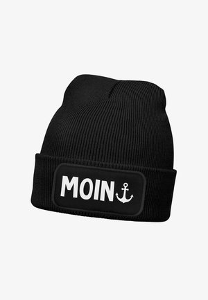 Black knitted beanie with a folded cuff featuring a rectangular patch that reads "MOIN" in bold white letters, accented by an anchor graphic.