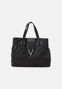 Black quilted handbag with a textured pattern, featuring dual handles and a front flap with a triangular metallic accent.