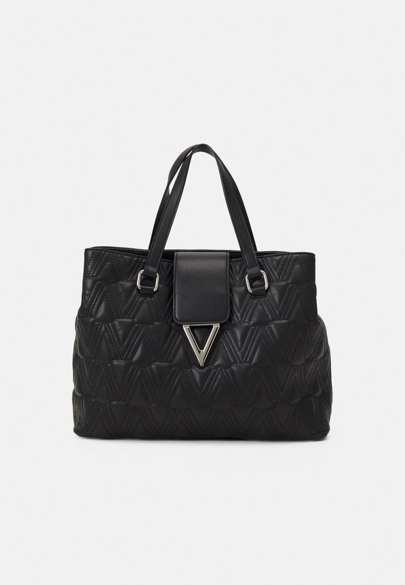 Black quilted handbag with a textured pattern, featuring dual handles and a front flap with a triangular metallic accent.