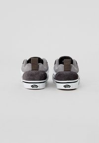 Graue Wildledersneaker mit einer weißen Gummisohle. Enthält eine Stoff-Fersenschlaufe, weiße Nähte und ein Logo auf der Außensohle.