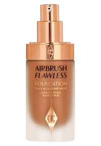 Airbrush Flawless Foundation in a clear glass bottle, featuring a gold pump and brown-to-clear gradient design. Text in black and gold.