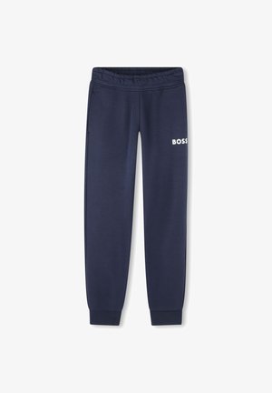 Pantalon de survêtement marine en tissu doux, avec une taille élastique, deux poches latérales et un logo "BOSS" blanc sur la cuisse gauche.