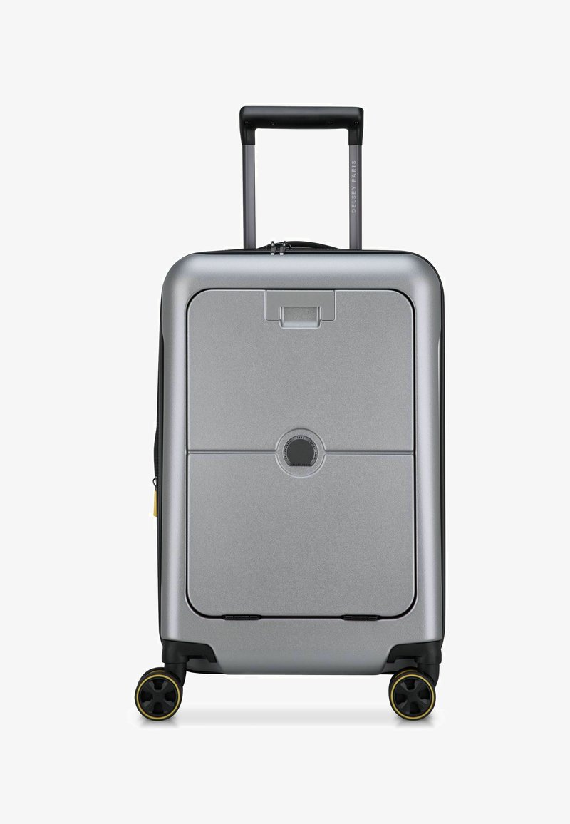 Valigia rigida argentata di forma rettangolare, con manico retrattile, due ruote con dettagli gialli e un sistema di chiusura centrale.