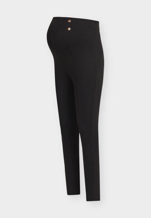 Zwarte zwangerschapsleggings met twee gouden knopen aan de taille, ontworpen voor een comfortabele pasvorm over een zwangere buik.