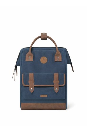 Navy canvas backpack with brown leather accents, featuring a top handle, two front straps, and a zip closure. Logo patch on front.